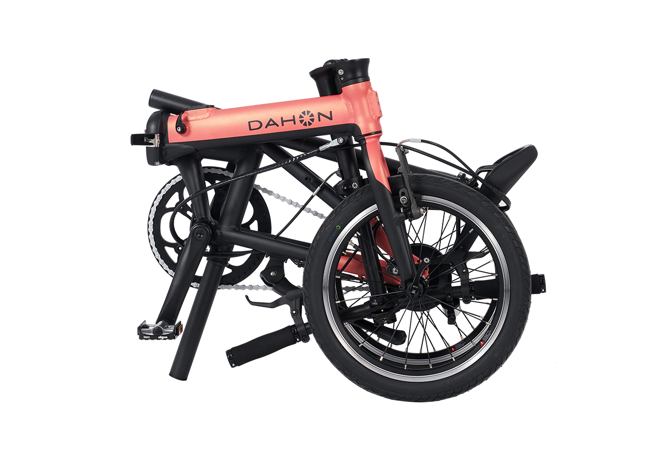 DAHON K-Feather electric bike in blush pink, shown folded for compact transport.