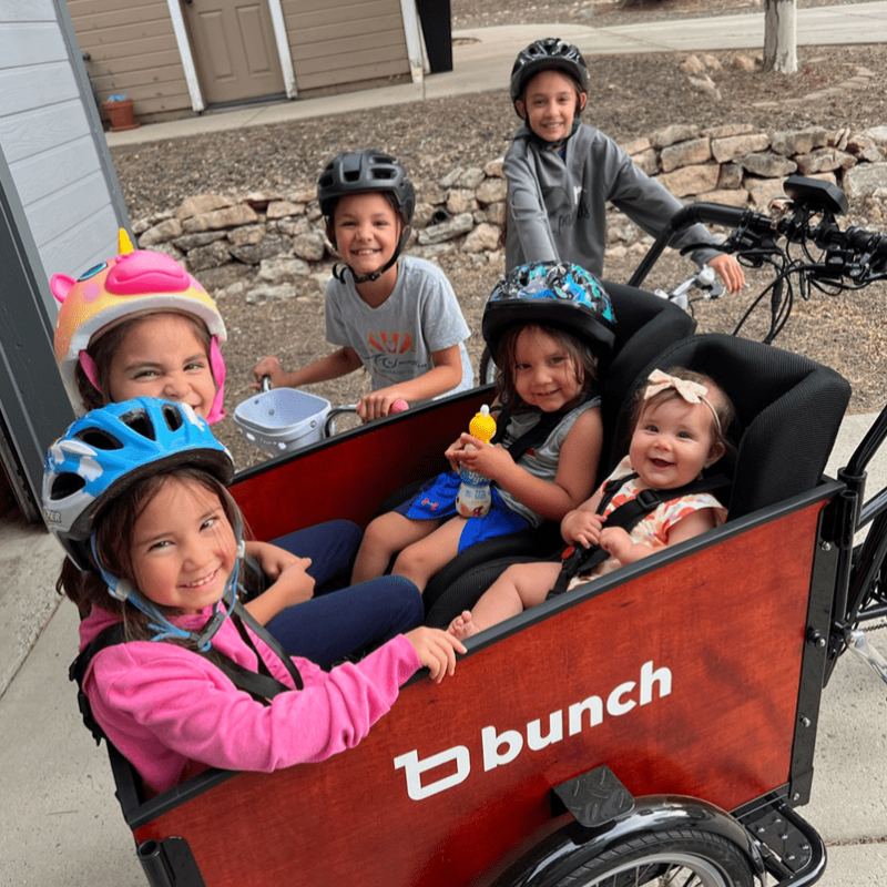 family bike ride with 2 toddlers, 2 older kids in cargo bike and 2 kids on their own bikes  #color_Sedona Woodgrain